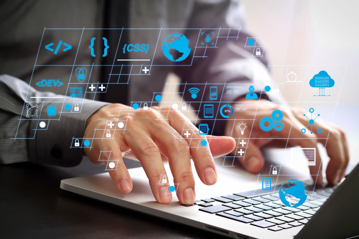 Custom software development workspace with multiple screens showing code and cloud services